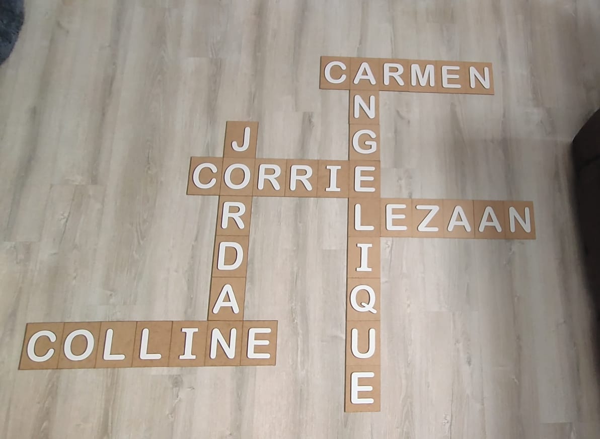 Cut wood letter tiles spelling out names